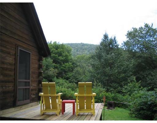 84 Moores Road Florida, MA 01343 - Photo 2 of 13 a view of a back yard of the house with a bench