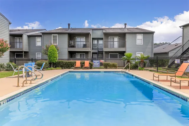 a view of a swimming pool with a patio