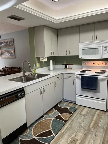 a kitchen with stainless steel appliances a stove a sink and cabinets