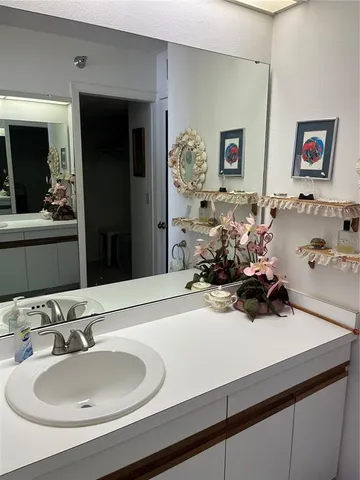 a bedroom with two beds and a chandelier