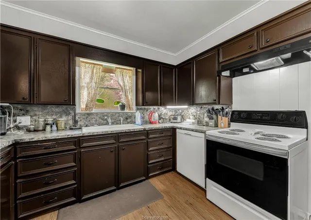a kitchen with a sink stove and microwave