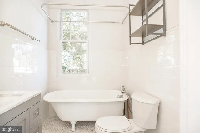 a bathroom with a toilet a sink and a bathtub