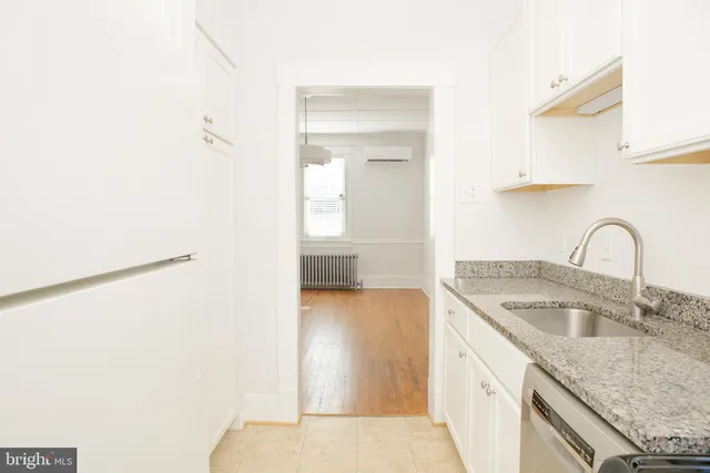a kitchen with a sink and a refrigerator