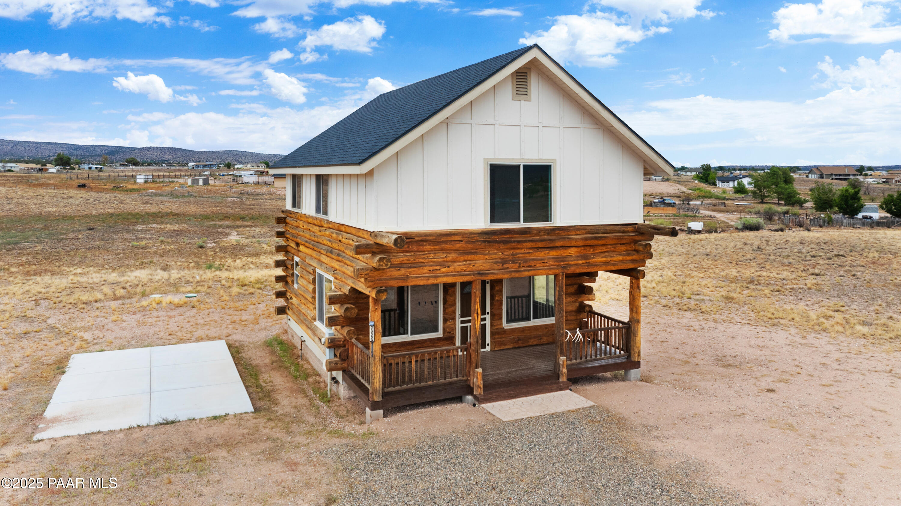 a view of a house with wooden deck and a ocean view