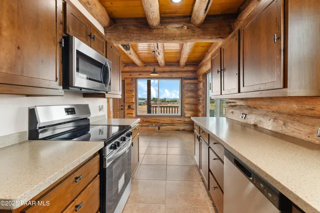 a kitchen with stainless steel appliances a stove sink microwave and cabinets