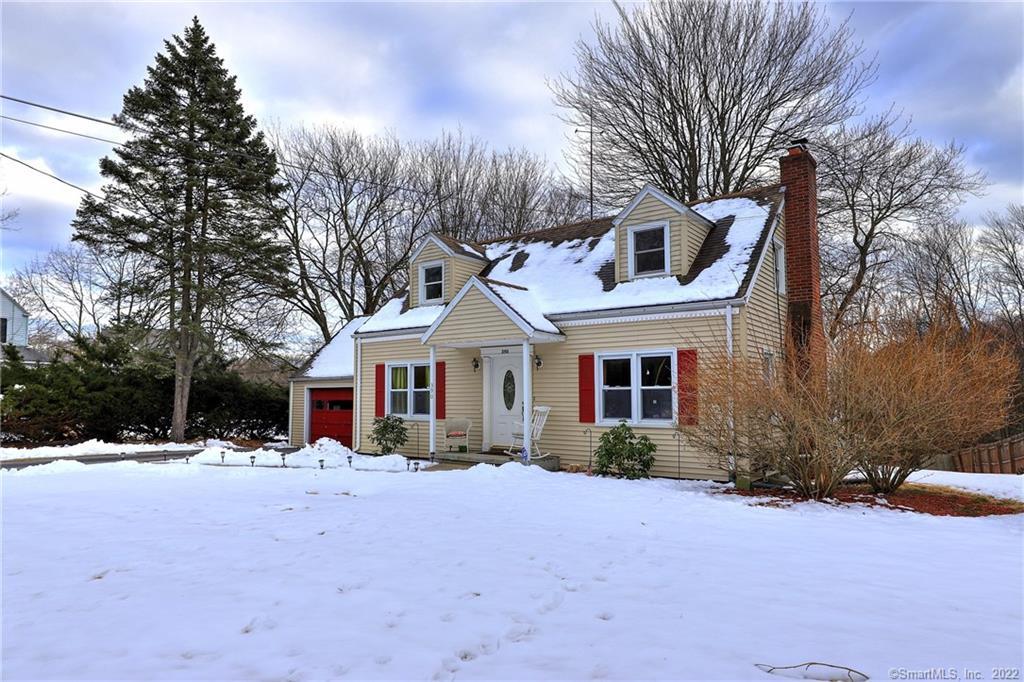 390 Broadbridge Road Bridgeport, CT 06610 - Photo 1 of 1 a front view of a house with a yard covered in snow