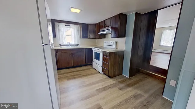 a kitchen with stainless steel appliances a refrigerator and a stove