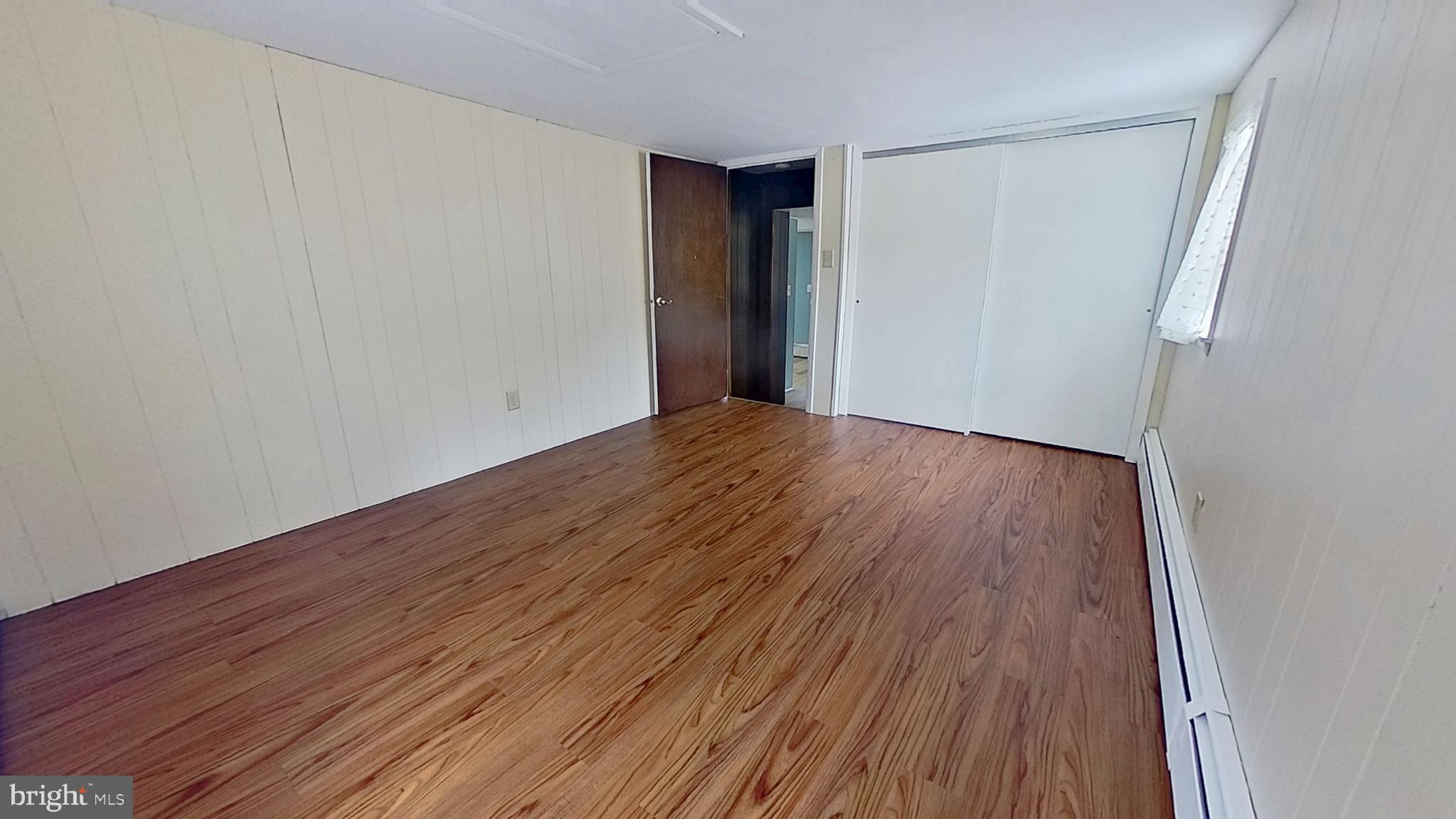 956 Toad Valley Road Glen Rock, PA 17327 - Photo 5 of 11 a view of an empty room with wooden floor and a window