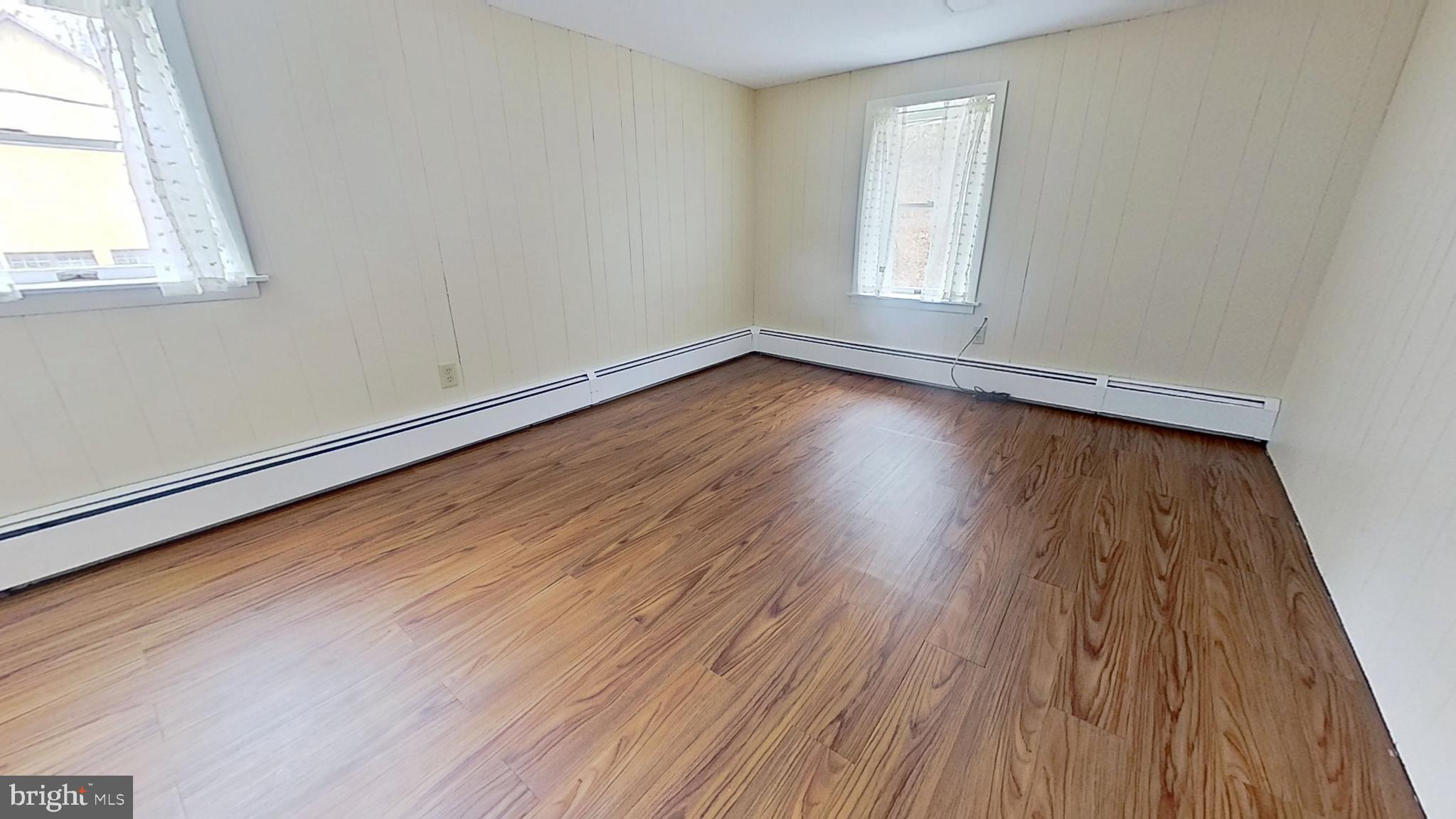 956 Toad Valley Road Glen Rock, PA 17327 - Photo 6 of 11 an empty room with wooden floor and windows