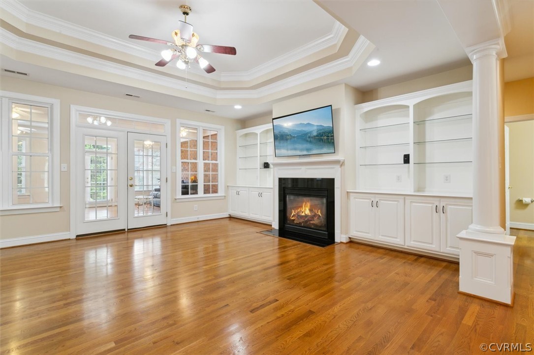 4035 Powhatan Secondary Williamsburg, VA 23188 - Photo 17 of 50 a view of an empty room with a fireplace and wooden floor next to windows