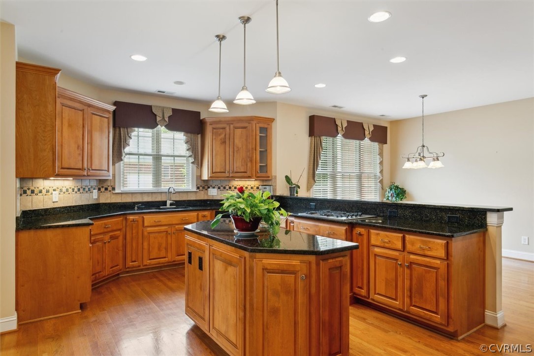 4035 Powhatan Secondary Williamsburg, VA 23188 - Photo 18 of 50 a kitchen with stainless steel appliances granite countertop sink stove and wooden cabinets