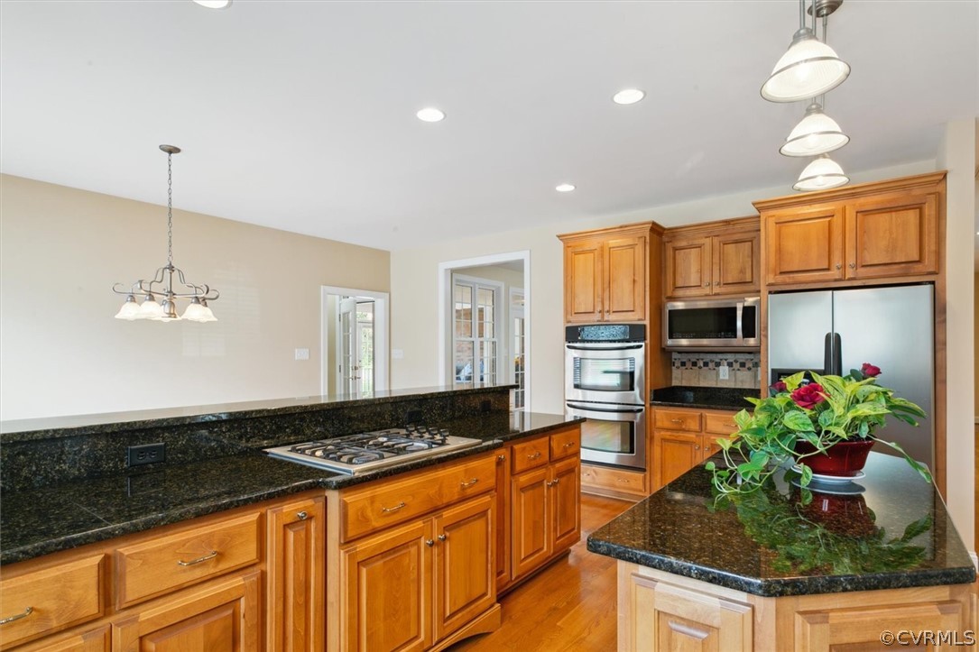 4035 Powhatan Secondary Williamsburg, VA 23188 - Photo 21 of 50 a kitchen with stainless steel appliances granite countertop a stove and cabinets