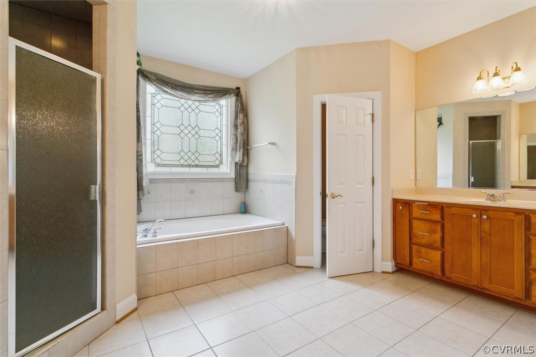 4035 Powhatan Secondary Williamsburg, VA 23188 - Photo 31 of 50 a spacious bathroom with a tub shower and sink