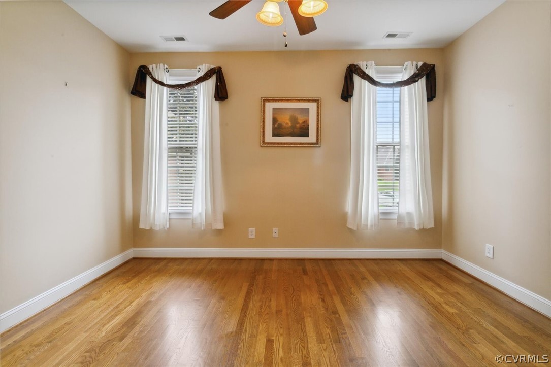 4035 Powhatan Secondary Williamsburg, VA 23188 - Photo 34 of 50 an empty room with wooden floor and windows