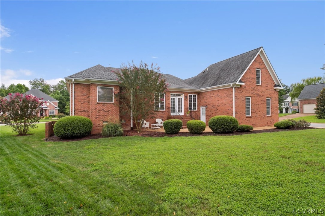 4035 Powhatan Secondary Williamsburg, VA 23188 - Photo 44 of 50 a view of a brick house with a big yard and large trees