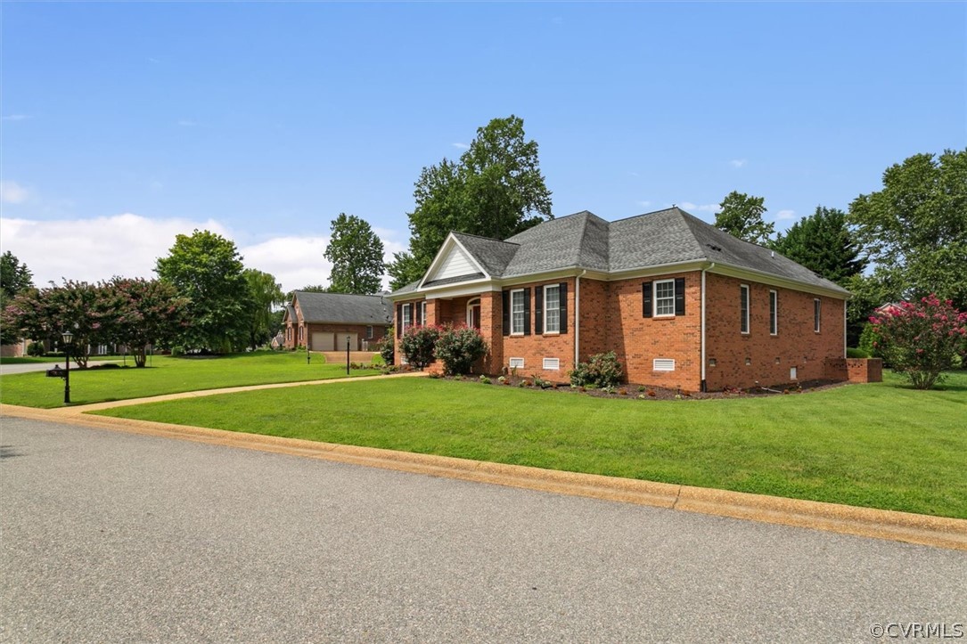 4035 Powhatan Secondary Williamsburg, VA 23188 - Photo 45 of 50 a front view of a house with a yard and trees