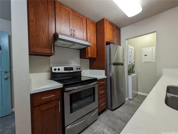 a kitchen with stainless steel appliances granite countertop a stove and a refrigerator