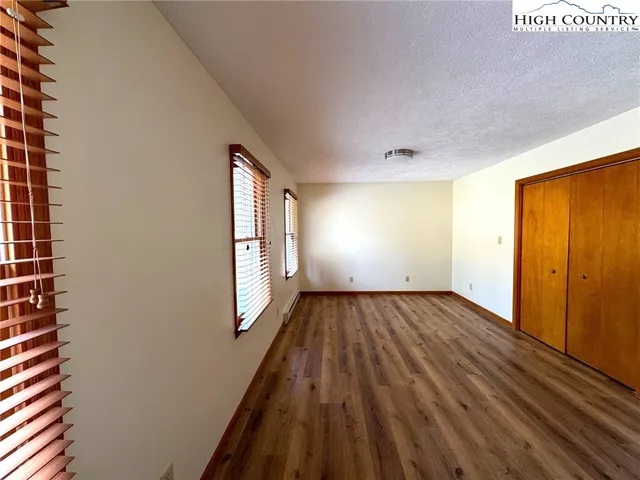 a view of a room with wooden floor and window