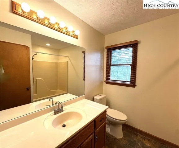 a bathroom with a sink toilet and mirror