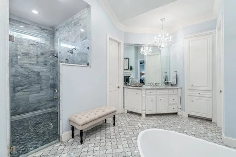 a spacious bathroom with a granite countertop sink a toilet and bathtub