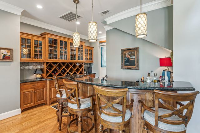 a kitchen with stainless steel appliances a sink and a chandelier