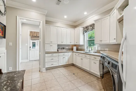 a kitchen with cabinets and window