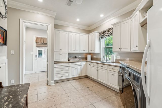 a kitchen with cabinets and window