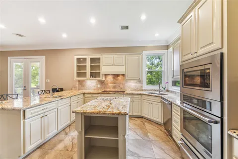 a kitchen with a stove sink and cabinets
