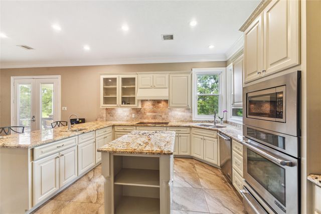 a kitchen with a stove sink and cabinets