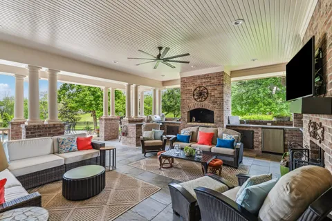 a living room with furniture fireplace and a large window