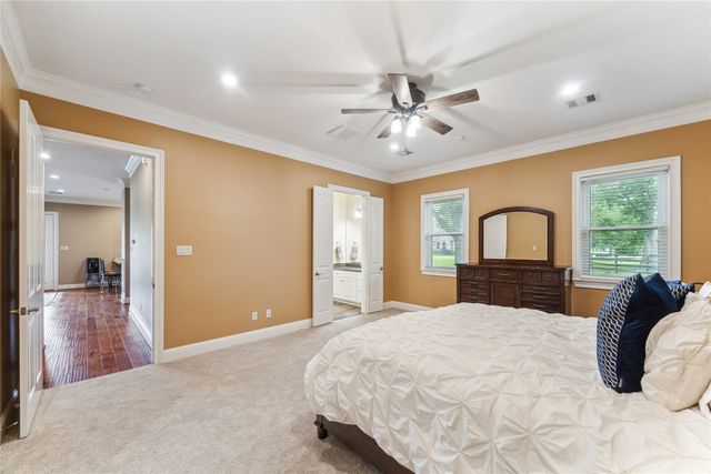 a bedroom with a large bed and a window