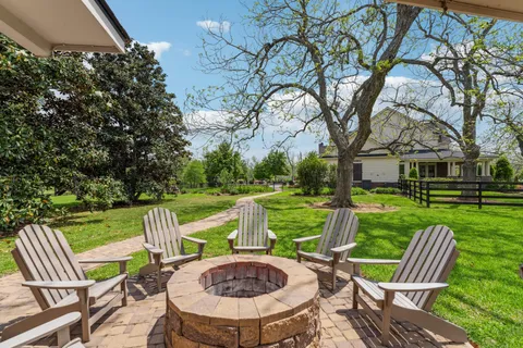 a view of backyard with swimming pool and green space