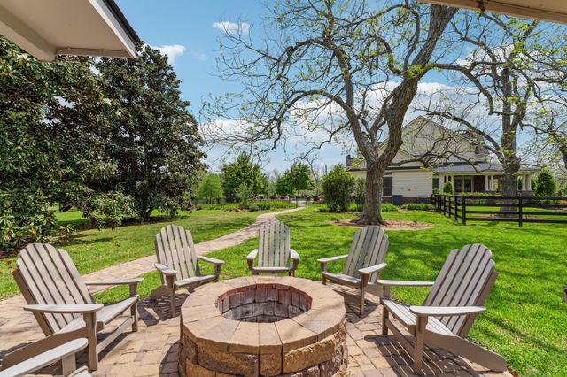 a view of backyard with swimming pool and green space
