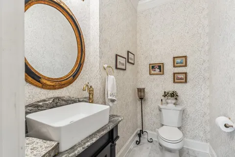 a bathroom with a sink a toilet and a mirror