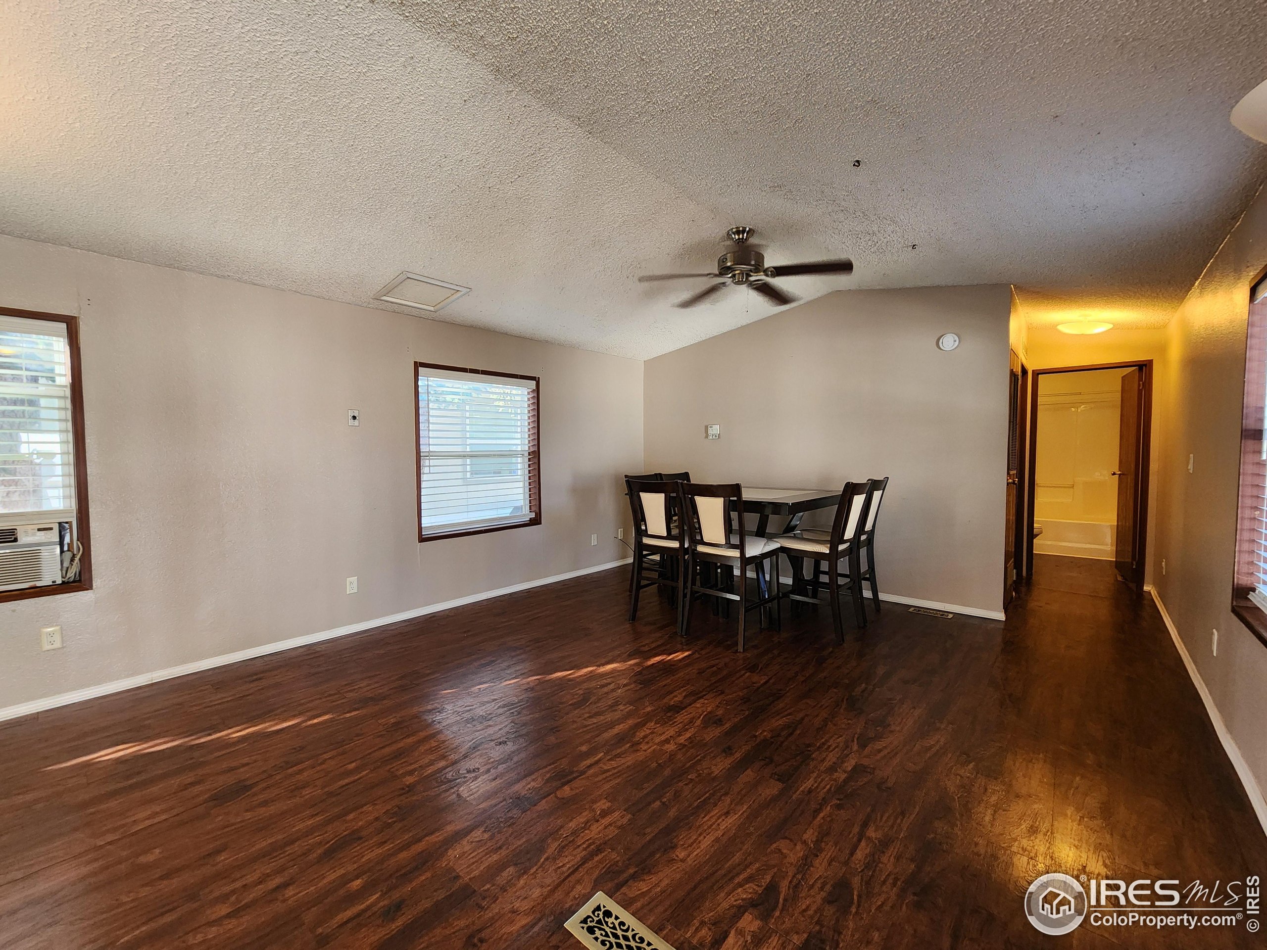 5000 Butte Street, Unit 208 Boulder, CO 80301 - Photo 11 of 37 a view of a room with wooden floor and a ceiling fan