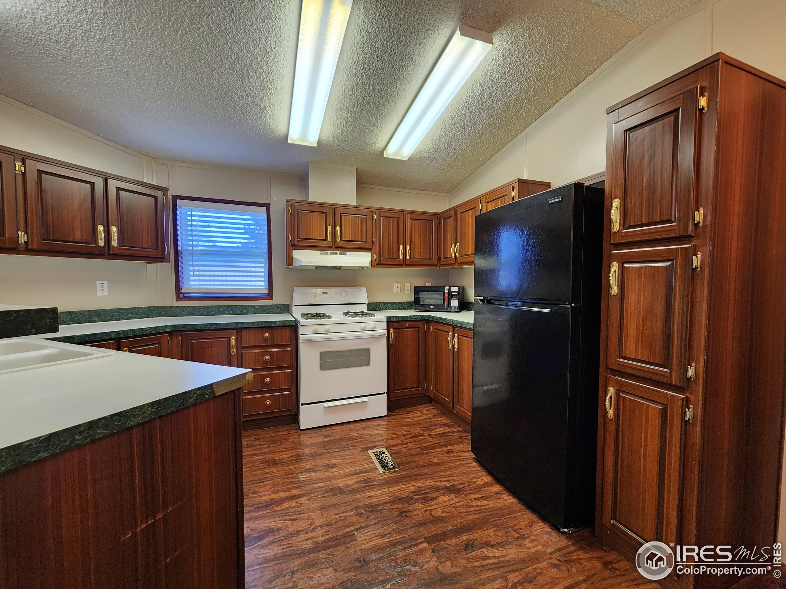 5000 Butte Street, Unit 208 Boulder, CO 80301 - Photo 4 of 37 a kitchen with granite countertop stainless steel appliances and wooden cabinets
