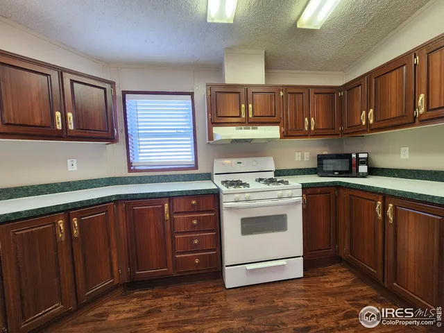 a kitchen with stainless steel appliances granite countertop a stove cabinets and a sink