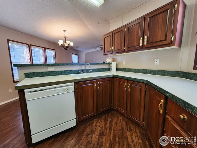 a kitchen with a sink cabinets and wooden floor