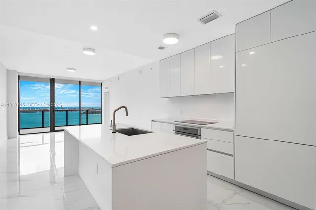 a kitchen with a sink and a refrigerator