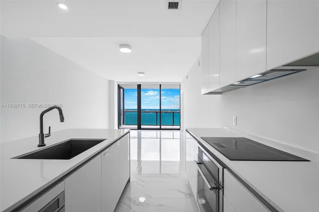 a kitchen that has a sink and a stove