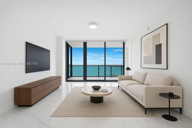 a living room with furniture and a lamp