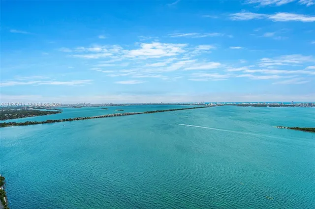 a view of a field with an ocean view