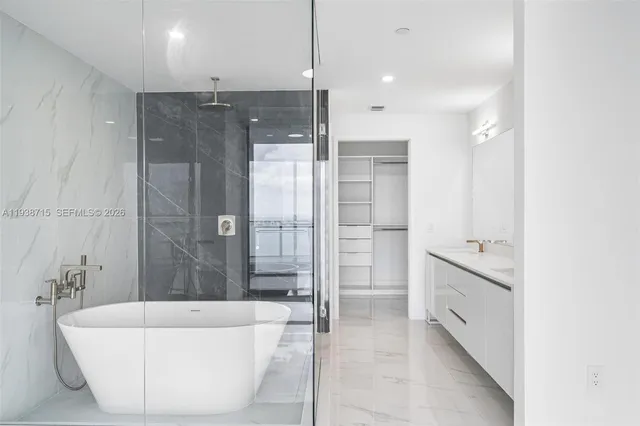 a bathroom with a bathtub and a shower