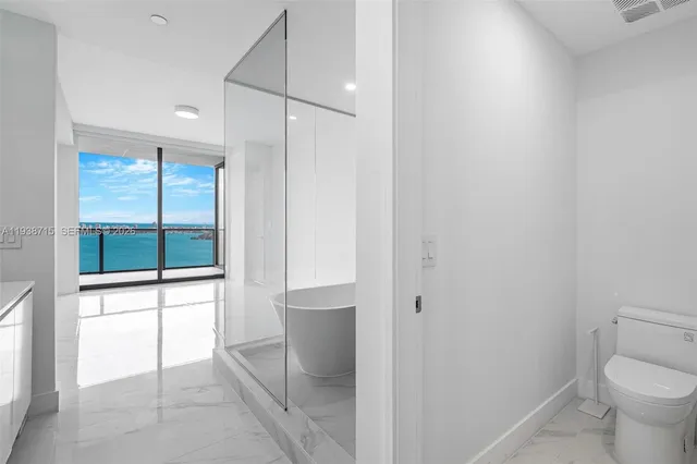 a bedroom with a bed and mirror