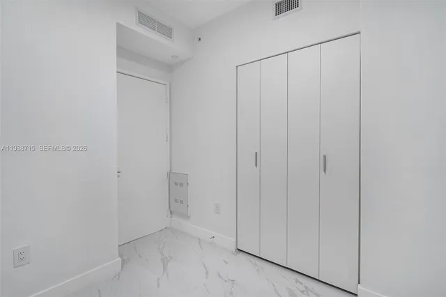 a bathroom with a toilet and a mirror