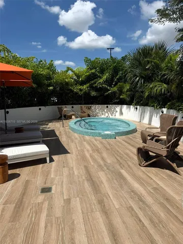 a view of empty room with floor to ceiling window and dining room