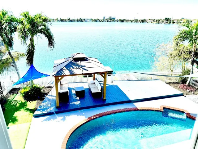 a small pool with lawn chairs