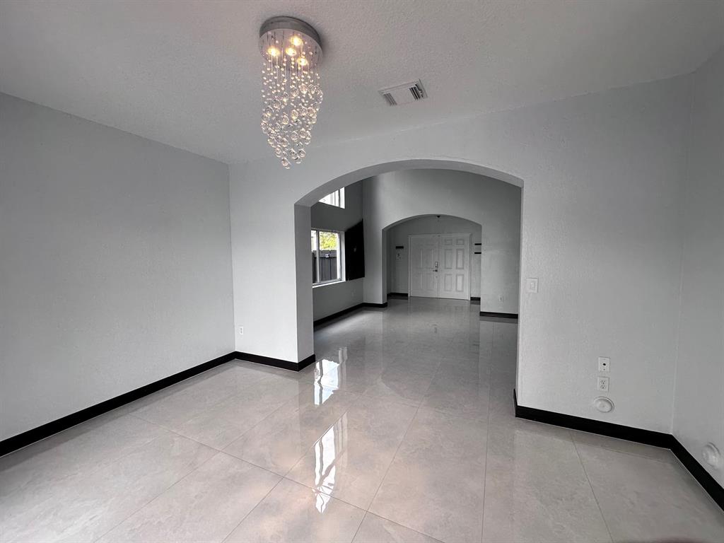 14024 Southwest 132nd Avenue Miami, FL 33186 - Photo 11 of 24 a view of empty room with a fireplace