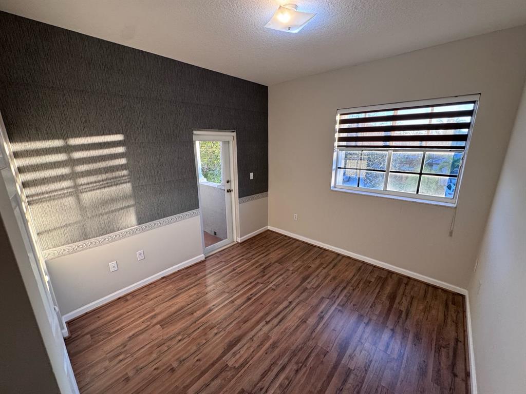 14024 Southwest 132nd Avenue Miami, FL 33186 - Photo 18 of 24 a view of empty room with wooden floor and fan