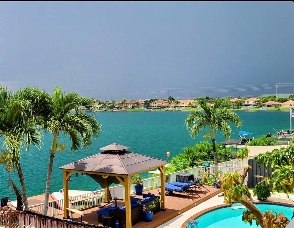 14024 Southwest 132nd Avenue Miami, FL 33186 - Photo 2 of 24 a view of a chairs and table in patio with a garden